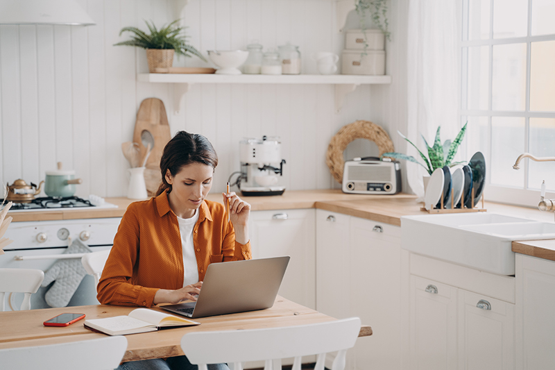 Woman working remotely from a ranch, demonstrating the flexibility of rural broadband services.